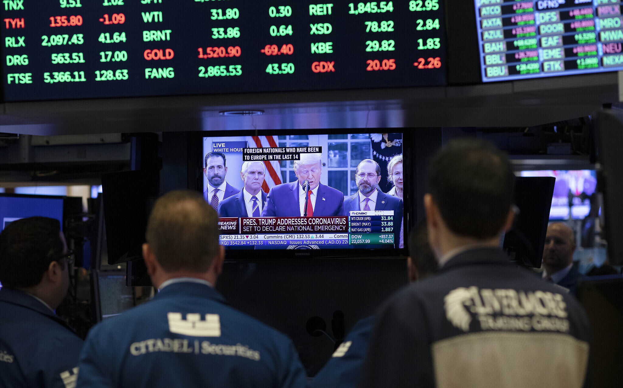 Traders listen at the New York Stock Exchange