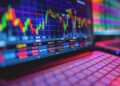 TitaniumInvest.com Stock Market: A close-up of a computer screen displaying colorful, fluctuating financial data and stock market charts from TitaniumInvest.com. The foreground shows part of a white keyboard, and the screen features various line graphs, bars, and numerical values in red, green, and yellow. | TitaniumInvest