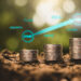 Three stacks of coins of increasing height sit on soil, symbolizing growth. Above them, interconnected words—"START," "INVEST IN MUTUAL FUNDS AND ETFs," "GROWTH," "PLAN," "SAVE," "FUTURE," and finally "GOAL"—are linked by arrows suggesting progress. | TitaniumInvest